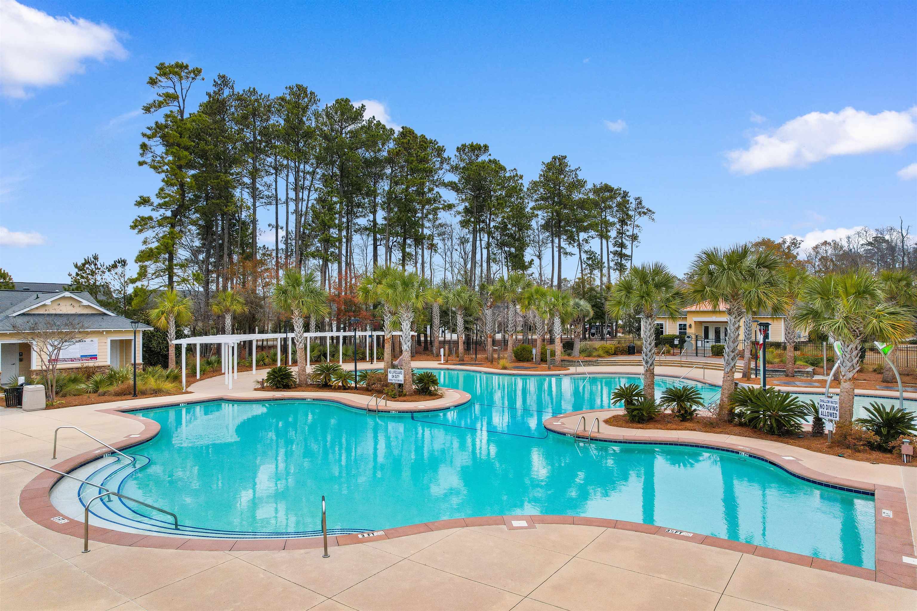 2408 Heritage Loop, Unit 2408 Myrtle Beach, SC 29577 - Photo 38 of 40 Community pool featuring a patio area and view of scattered trees