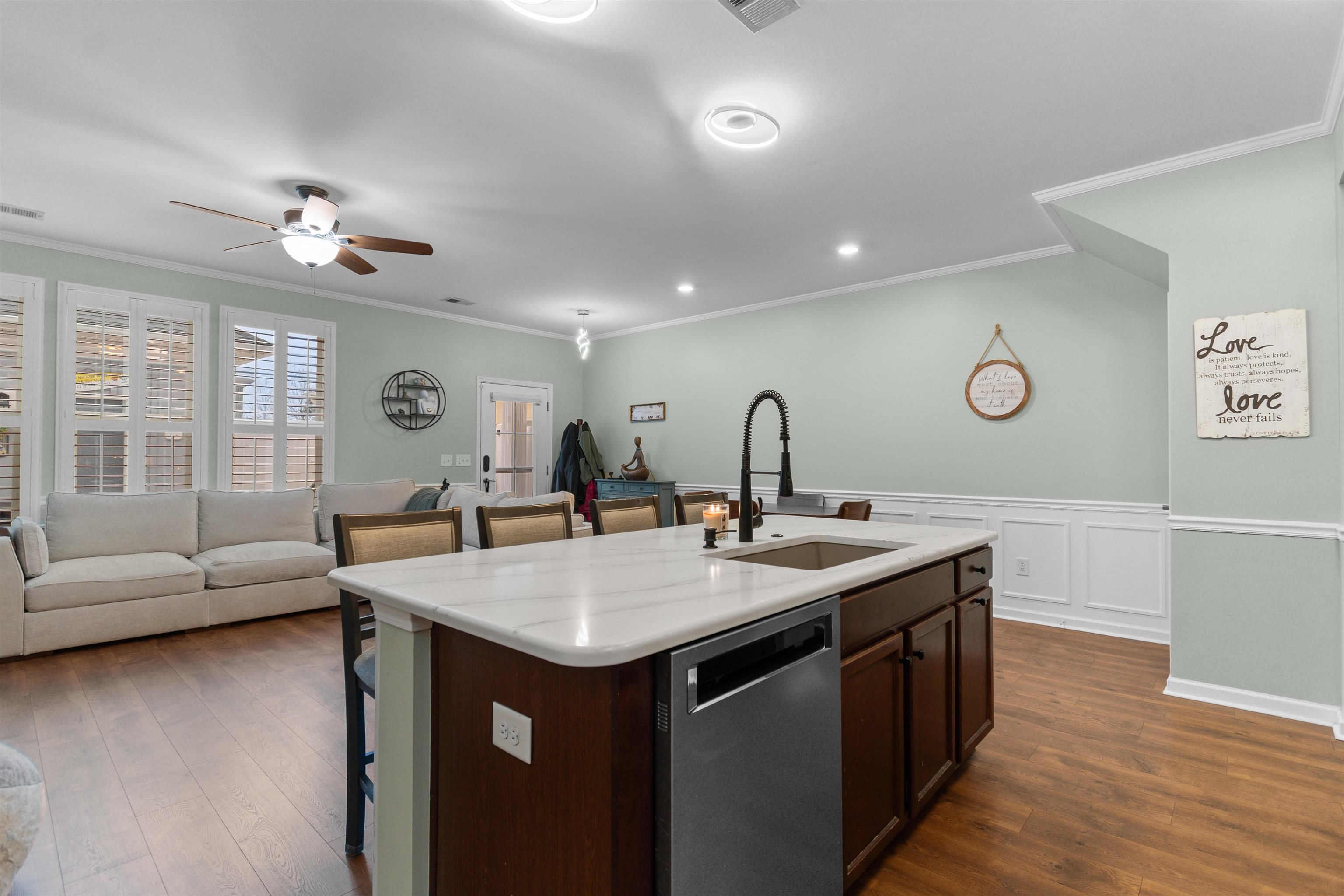 2408 Heritage Loop, Unit 2408 Myrtle Beach, SC 29577 - Photo 40 of 40 Kitchen featuring dark brown cabinets, dishwasher, open floor plan, a breakfast bar area, and dark wood-type flooring