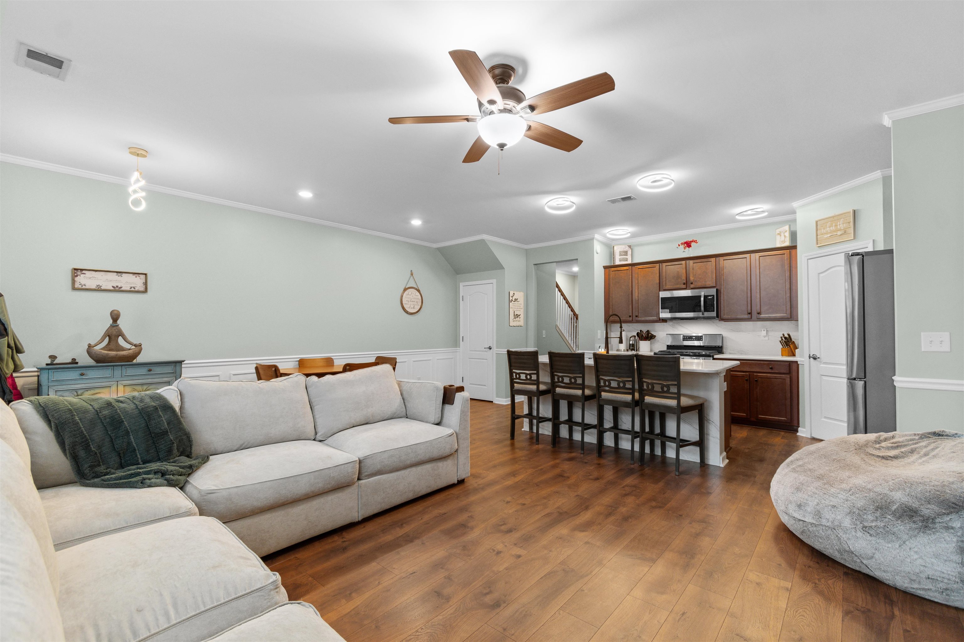 2408 Heritage Loop, Unit 2408 Myrtle Beach, SC 29577 - Photo 8 of 40 Living room featuring ornamental molding, ceiling fan, dark wood-style floors, recessed lighting, and a wainscoted wall