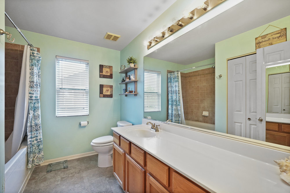 1962 Ashbrooke Road Romeoville, IL 60446 - Photo 13 of 21 a spacious bathroom with a double vanity sink toilet and a tub