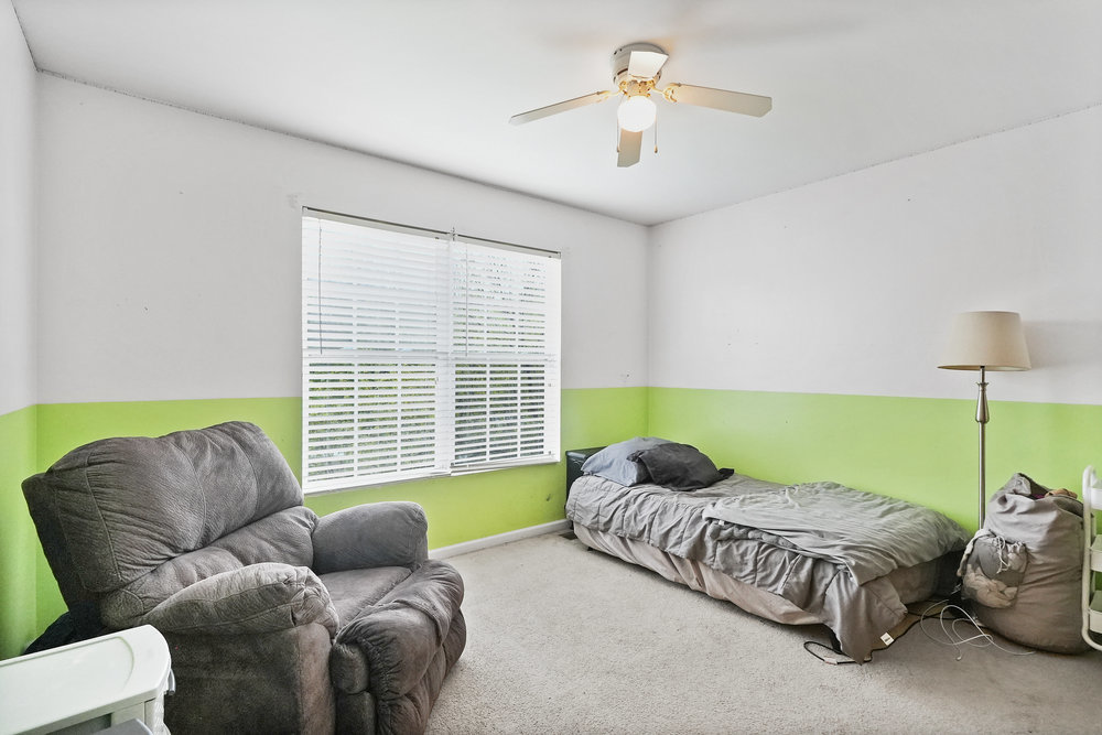1962 Ashbrooke Road Romeoville, IL 60446 - Photo 14 of 21 a living room with a bed and a chandelier