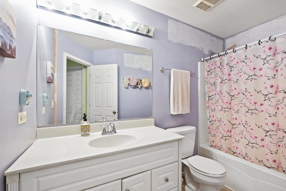 1962 Ashbrooke Road Romeoville, IL 60446 - Photo 15 of 21 a bathroom with a sink a toilet and shower curtain