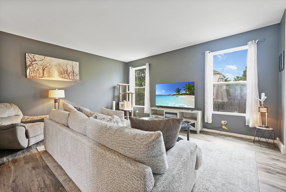 1962 Ashbrooke Road Romeoville, IL 60446 - Photo 2 of 21 a living room with furniture and a flat screen tv
