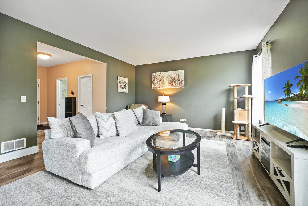 1962 Ashbrooke Road Romeoville, IL 60446 - Photo 3 of 21 a living room with furniture and a flat screen tv