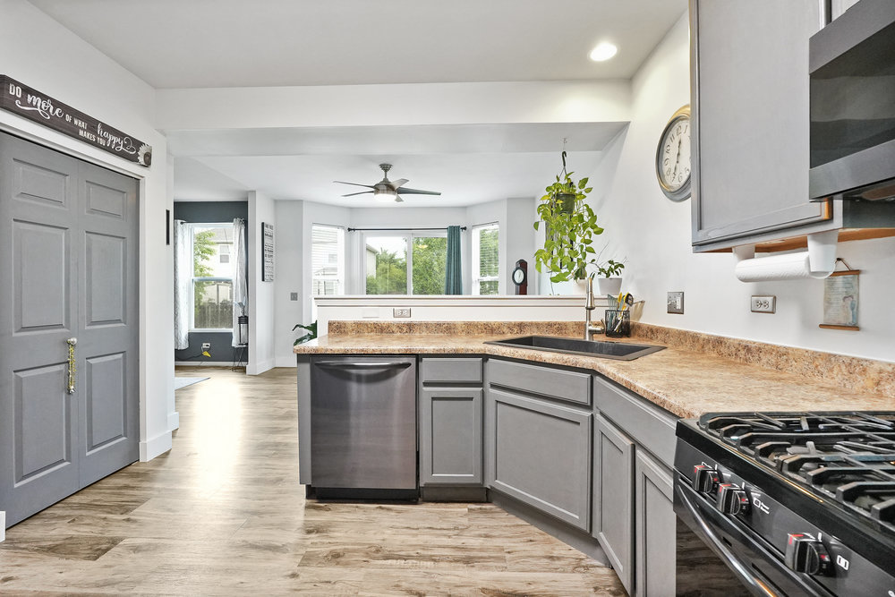 1962 Ashbrooke Road Romeoville, IL 60446 - Photo 5 of 21 a kitchen with stainless steel appliances granite countertop a sink stove and cabinets
