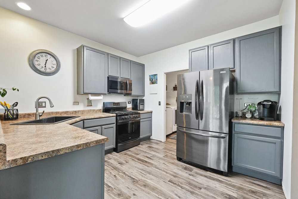 1962 Ashbrooke Road Romeoville, IL 60446 - Photo 6 of 21 a kitchen with granite countertop a refrigerator stove and sink