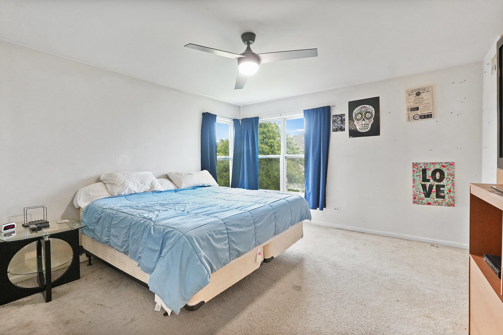 1962 Ashbrooke Road Romeoville, IL 60446 - Photo 10 of 21 a bed sitting in a spacious bedroom next to a window