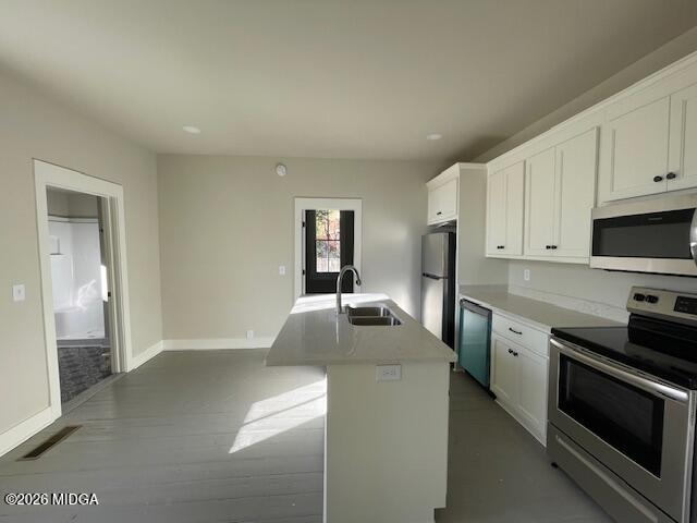 1121 Columbus Street, Unit A Macon, GA 31201 - Photo 5 of 6 a kitchen with stainless steel appliances granite countertop a stove and a refrigerator