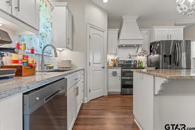 a kitchen with stainless steel appliances granite countertop a sink stove and refrigerator