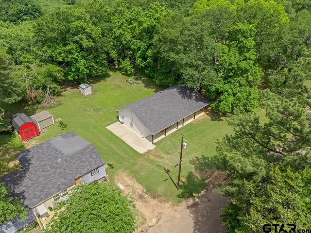 an aerial view of a house with a swimming pool