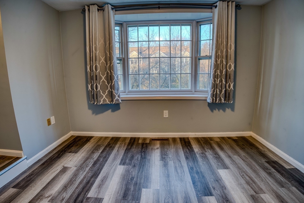 43 Patrick Road, Unit 43 Tewksbury, MA 01876 - Photo 13 of 27 a view of a room with wooden floor and small window