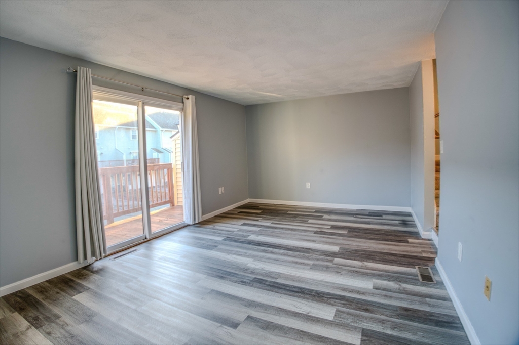 43 Patrick Road, Unit 43 Tewksbury, MA 01876 - Photo 14 of 27 a view of empty room with wooden floor and fan