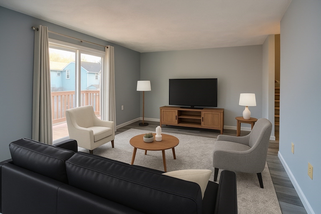 43 Patrick Road, Unit 43 Tewksbury, MA 01876 - Photo 15 of 27 a living room with furniture and a flat screen tv