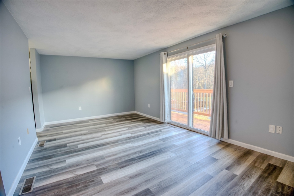 43 Patrick Road, Unit 43 Tewksbury, MA 01876 - Photo 16 of 27 a view of empty room with wooden floor and fan