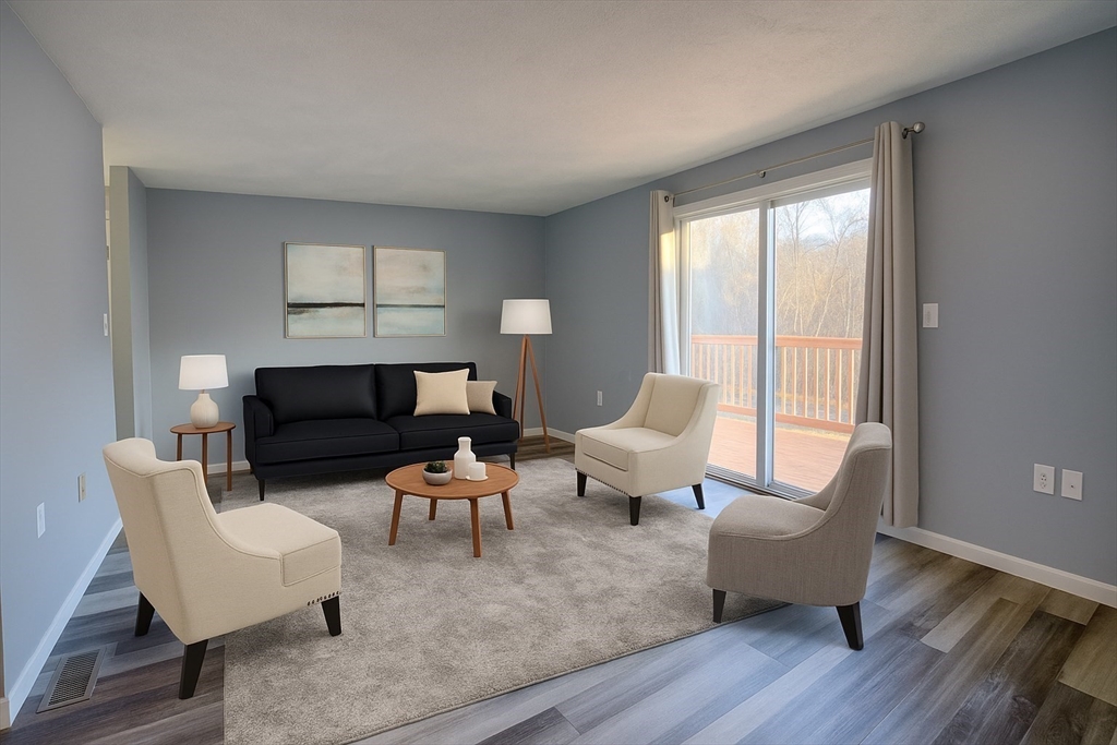 43 Patrick Road, Unit 43 Tewksbury, MA 01876 - Photo 17 of 27 a living room with furniture and a large window