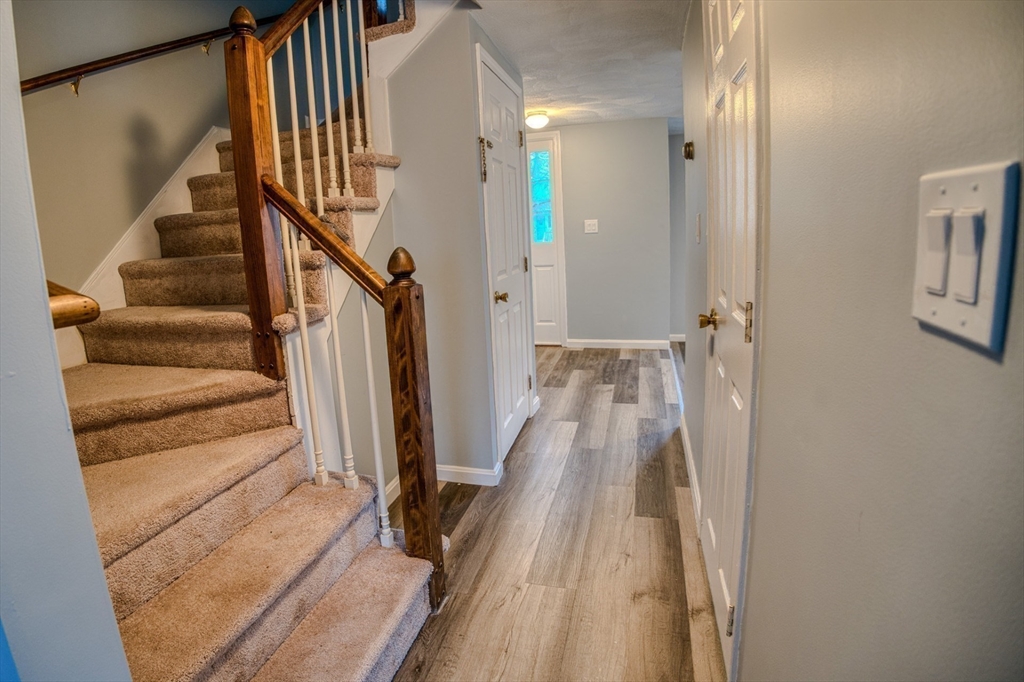 43 Patrick Road, Unit 43 Tewksbury, MA 01876 - Photo 18 of 27 a view of a hallway with wooden floor and staircase