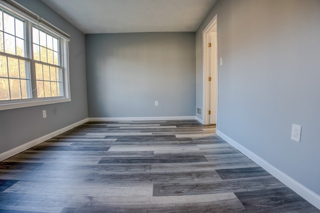 43 Patrick Road, Unit 43 Tewksbury, MA 01876 - Photo 20 of 27 a view of wooden floor and windows in a room