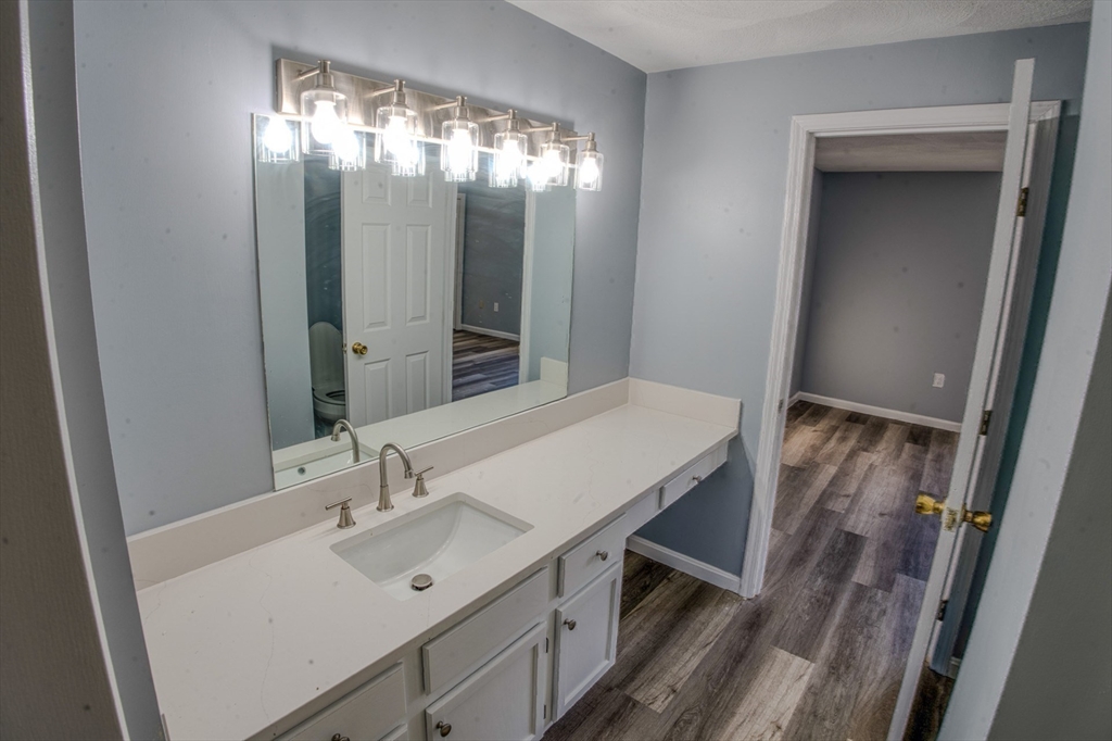 43 Patrick Road, Unit 43 Tewksbury, MA 01876 - Photo 22 of 27 a bathroom with a sink vanity and mirror