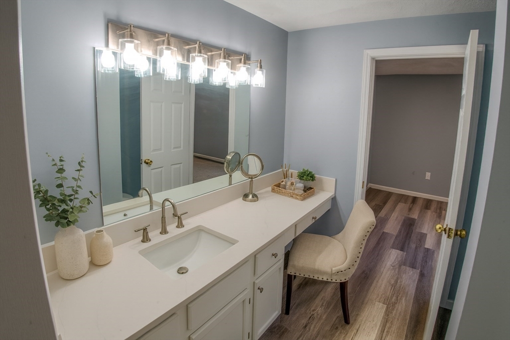 43 Patrick Road, Unit 43 Tewksbury, MA 01876 - Photo 23 of 27 a en suite bathroom with a sink double vanity and mirror
