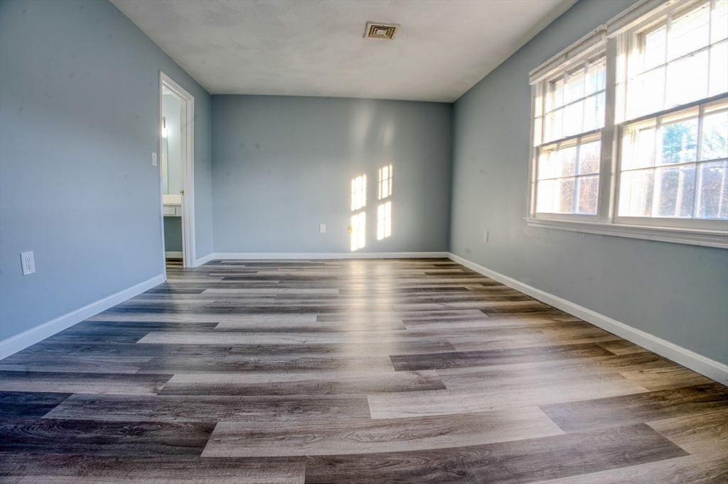 43 Patrick Road, Unit 43 Tewksbury, MA 01876 - Photo 25 of 27 wooden floor in an empty room with a window