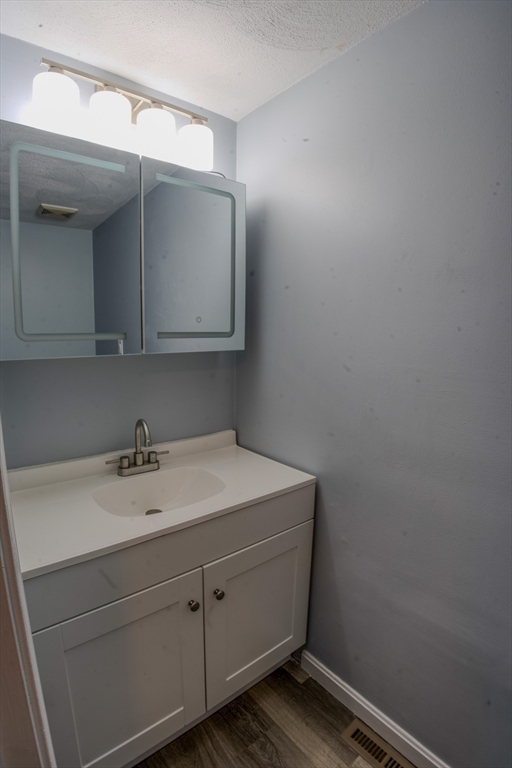 43 Patrick Road, Unit 43 Tewksbury, MA 01876 - Photo 6 of 27 a bathroom with a sink and vanity
