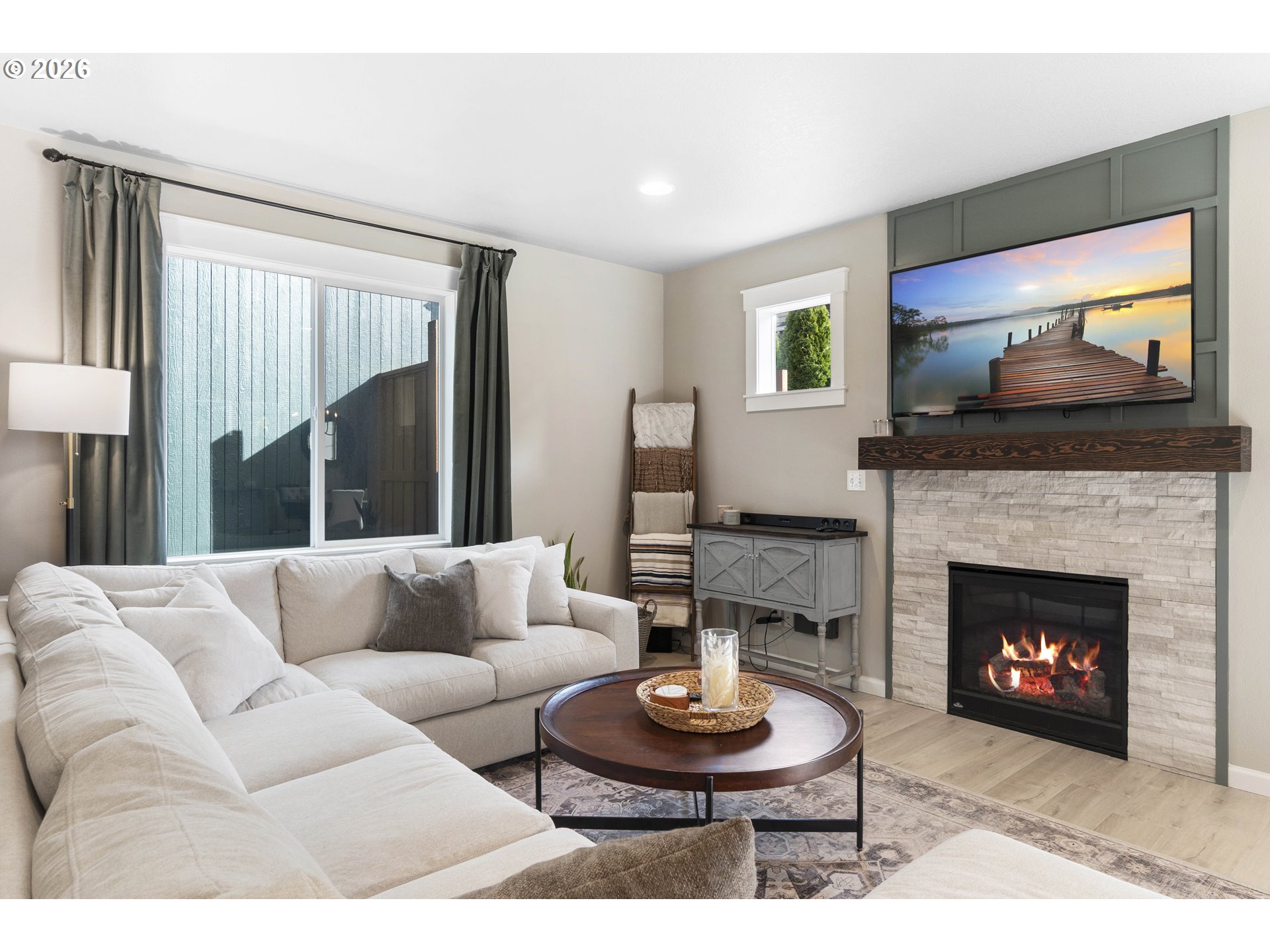 15520 Rainier Avenue Sandy, OR 97055 - Photo 11 of 38 a living room with furniture a fireplace and a flat screen tv