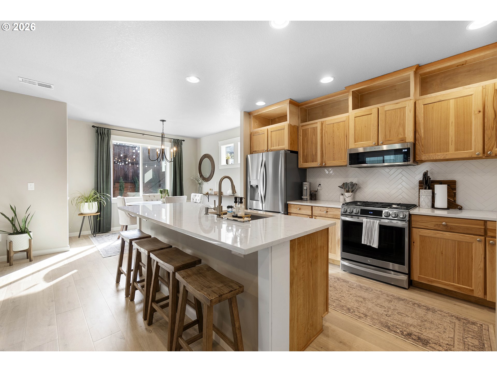 15520 Rainier Avenue Sandy, OR 97055 - Photo 12 of 38 a kitchen with stainless steel appliances kitchen island granite countertop a sink and cabinets