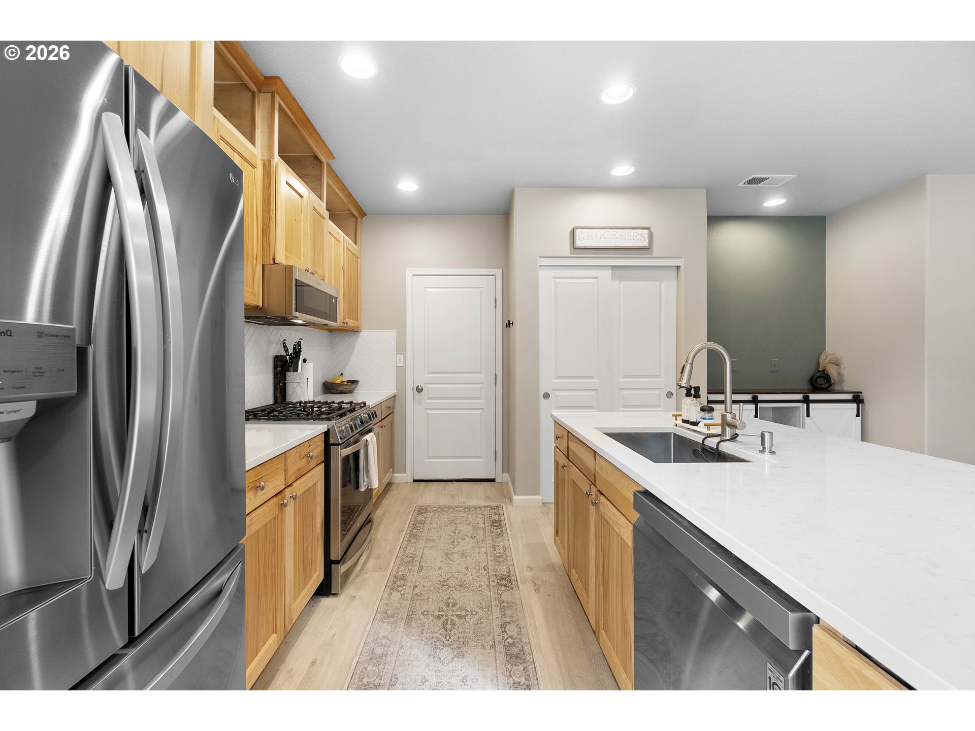 15520 Rainier Avenue Sandy, OR 97055 - Photo 13 of 38 a kitchen with stainless steel appliances granite countertop a sink refrigerator and cabinets