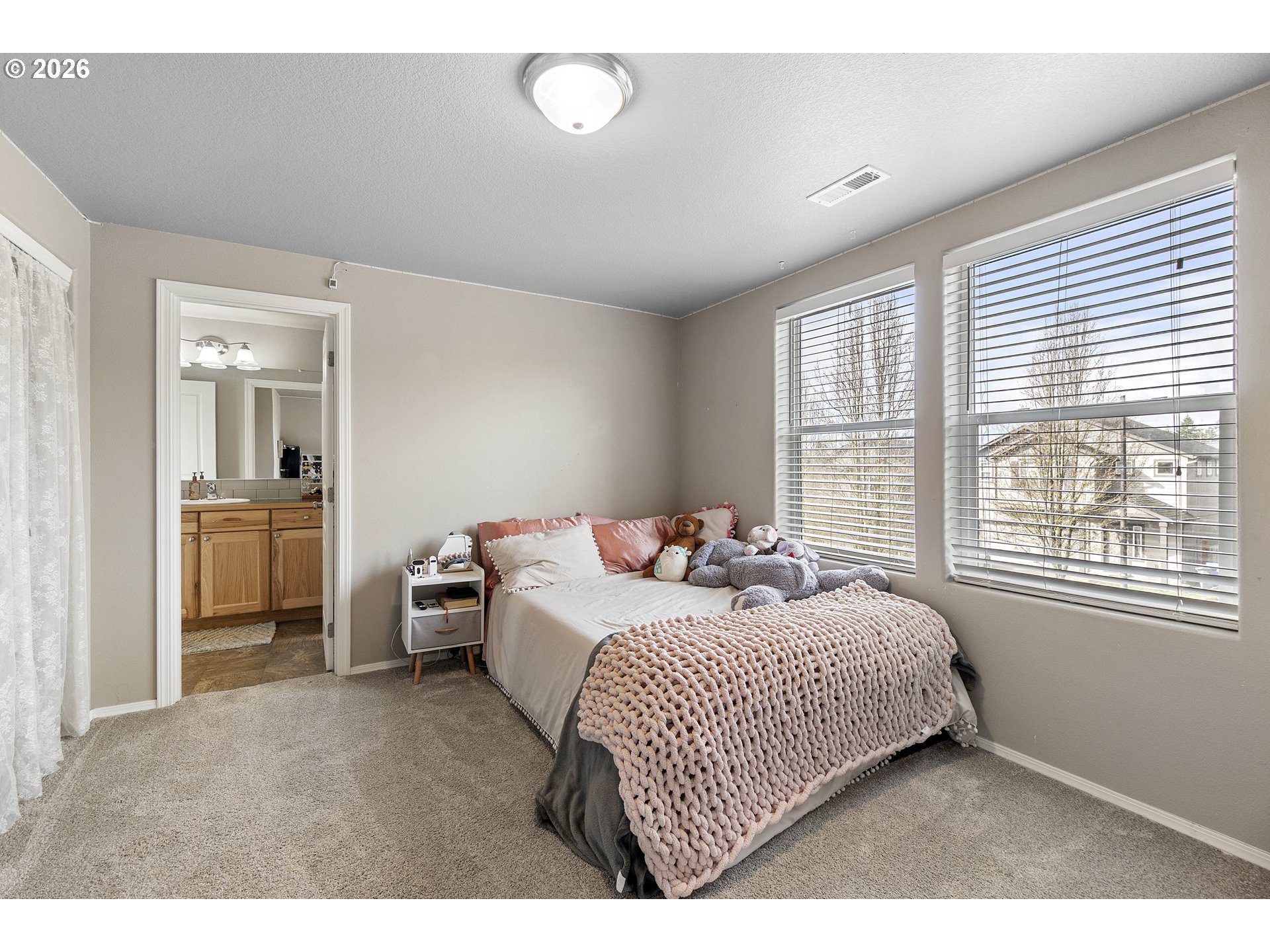15520 Rainier Avenue Sandy, OR 97055 - Photo 22 of 38 a bedroom with a bed and a large window