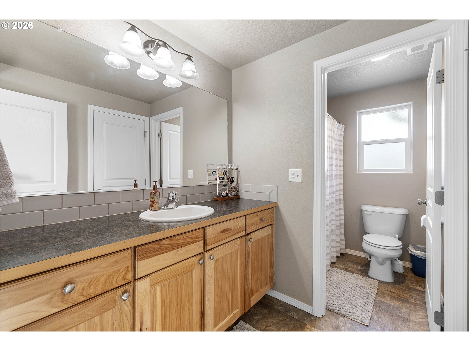 15520 Rainier Avenue Sandy, OR 97055 - Photo 23 of 38 a bathroom with a sink a toilet and a mirror