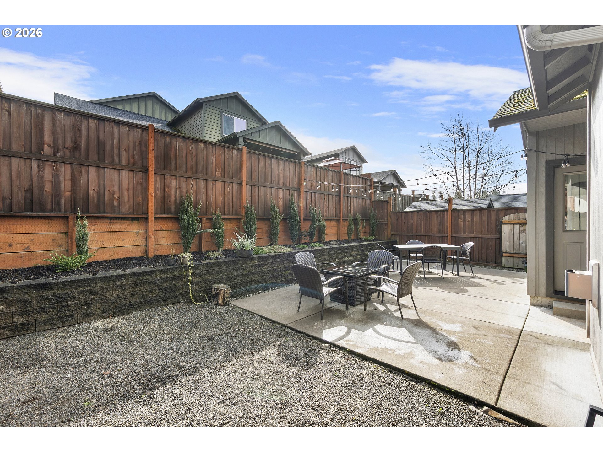 15520 Rainier Avenue Sandy, OR 97055 - Photo 26 of 38 a view of a patio with table and chairs with wooden fence