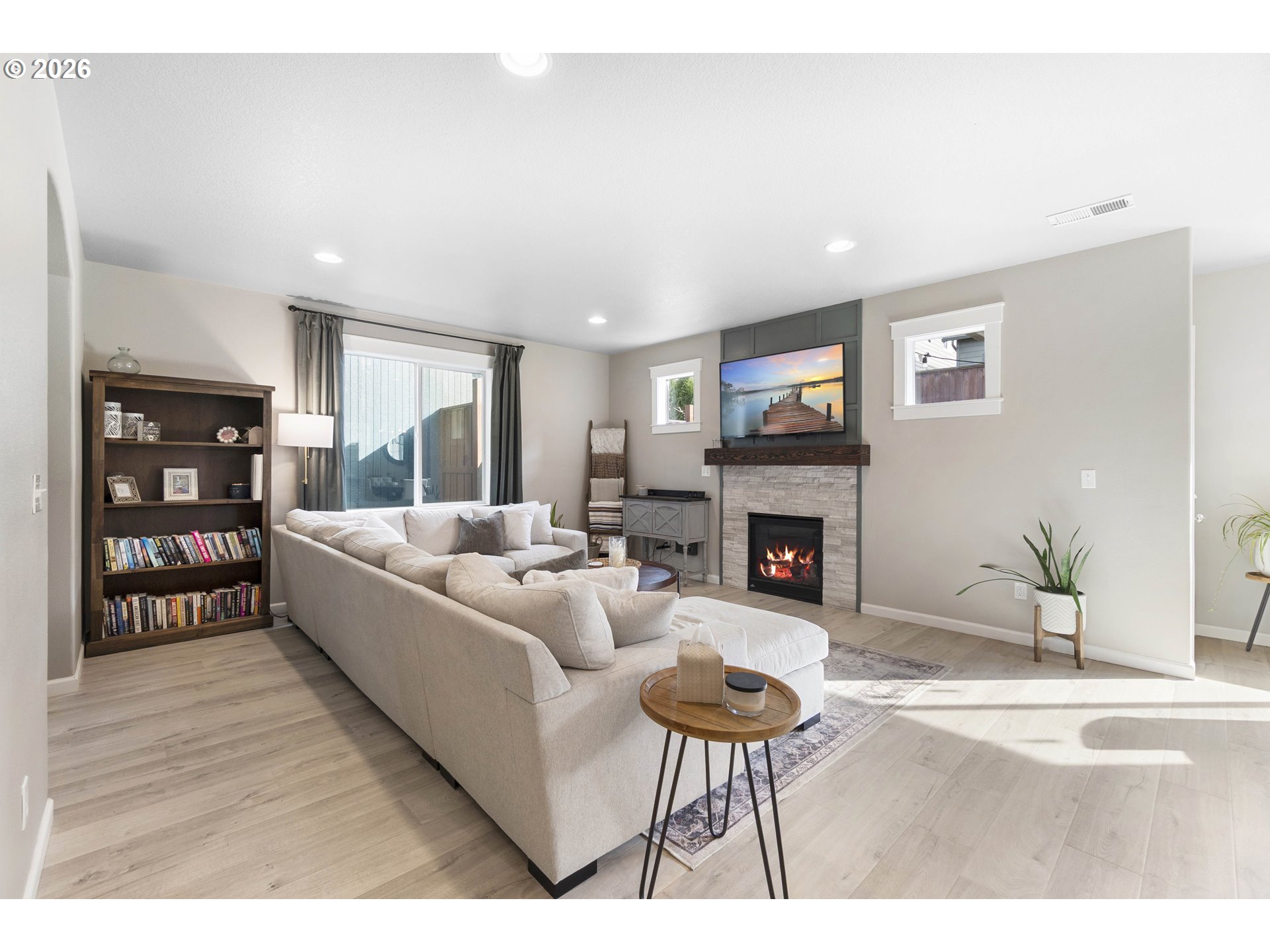 15520 Rainier Avenue Sandy, OR 97055 - Photo 7 of 38 a living room with furniture a fireplace and a bookshelf