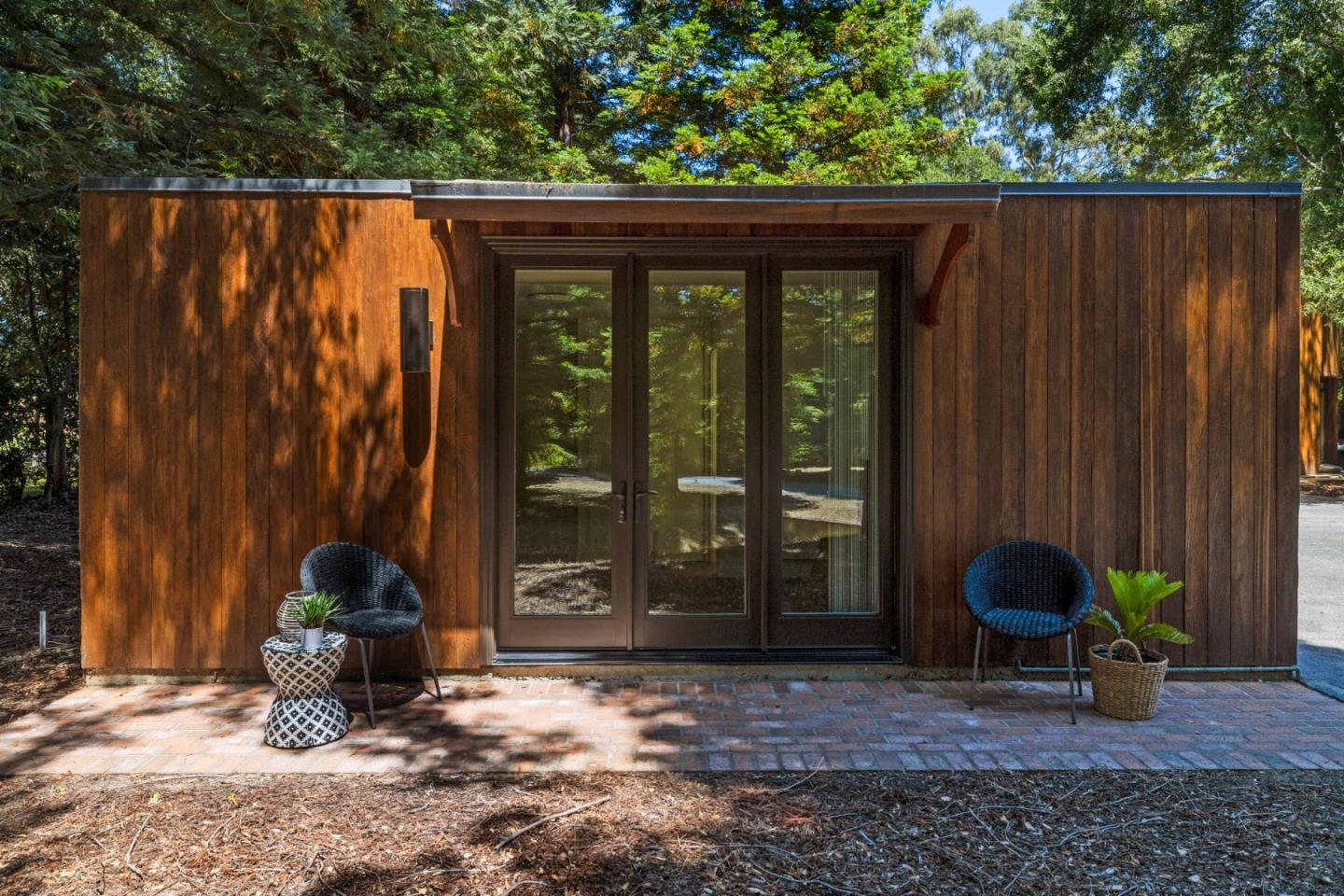 3364 Woodside Road Woodside, CA 94062 - Photo 40 of 48 a backyard of a house with barbeque oven table and chairs