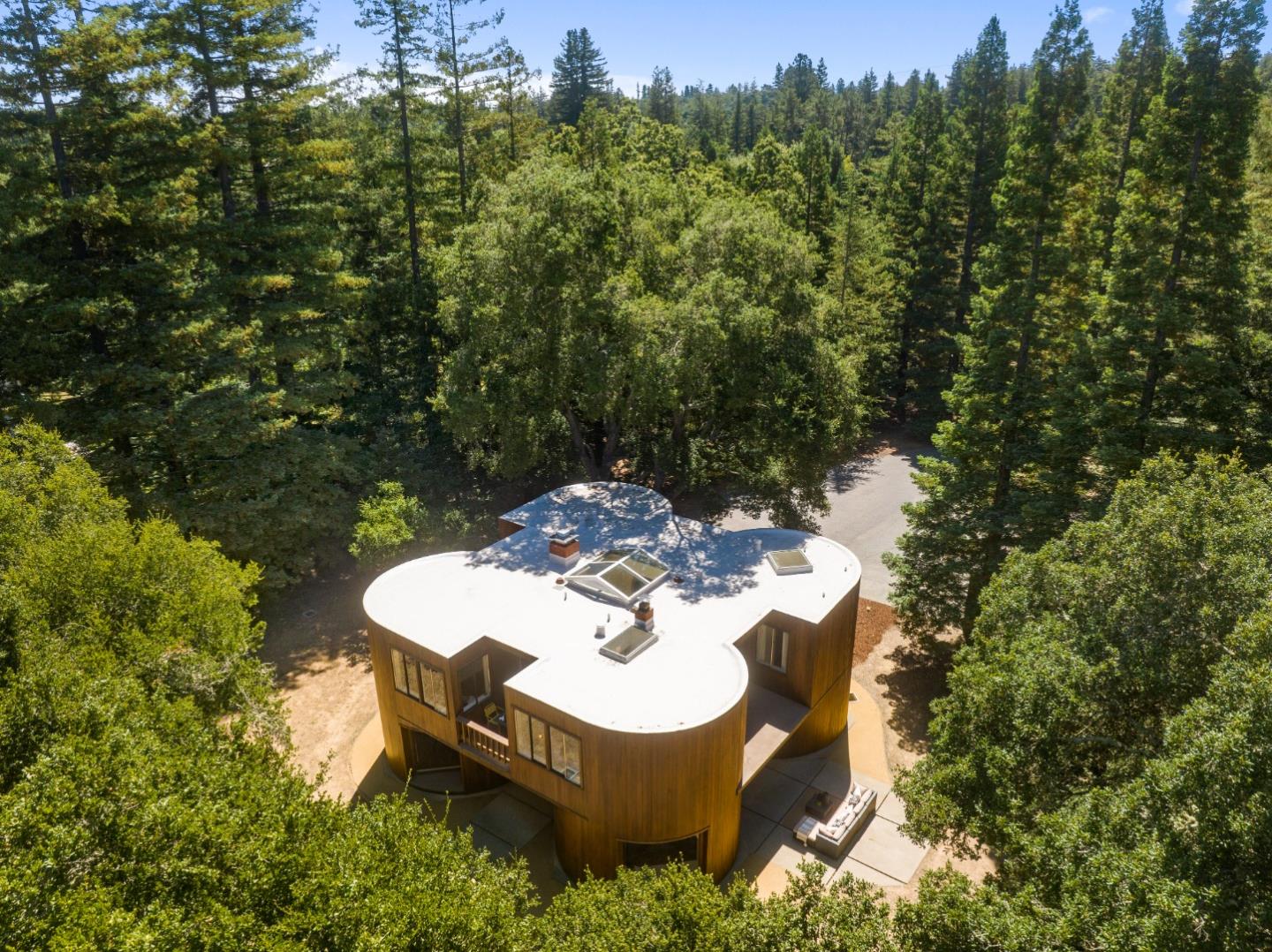 3364 Woodside Road Woodside, CA 94062 - Photo 4 of 48 a wooden bench sitting in the middle of a forest