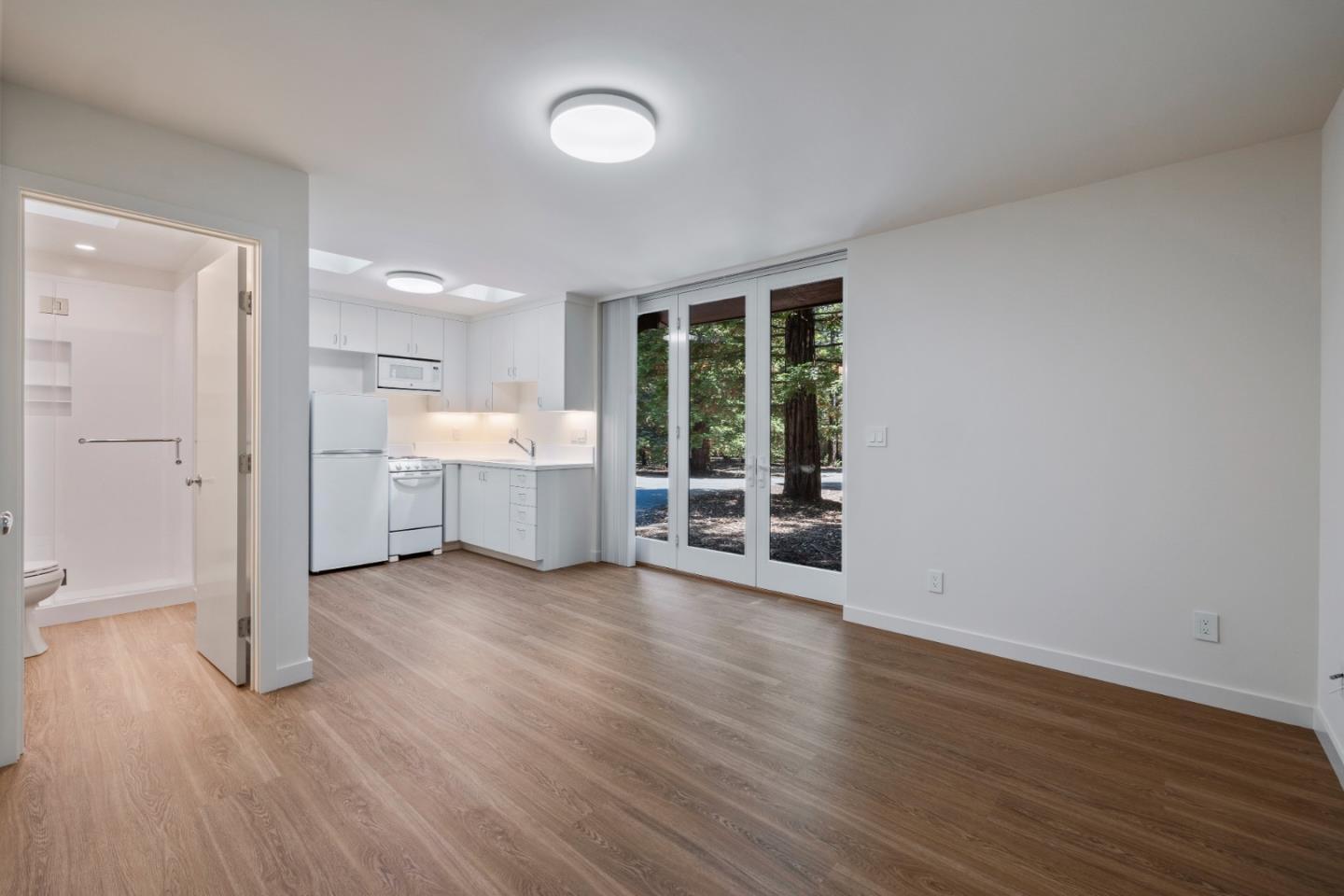 3364 Woodside Road Woodside, CA 94062 - Photo 42 of 48 an empty room with wooden floor and windows