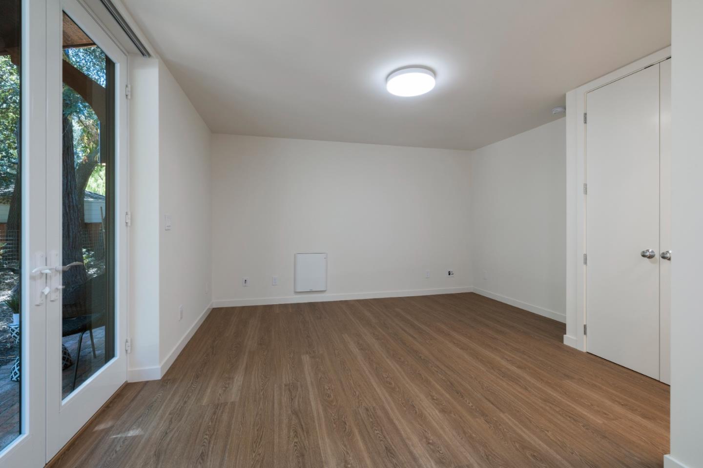 3364 Woodside Road Woodside, CA 94062 - Photo 44 of 48 a view of an empty room with wooden floor and a window