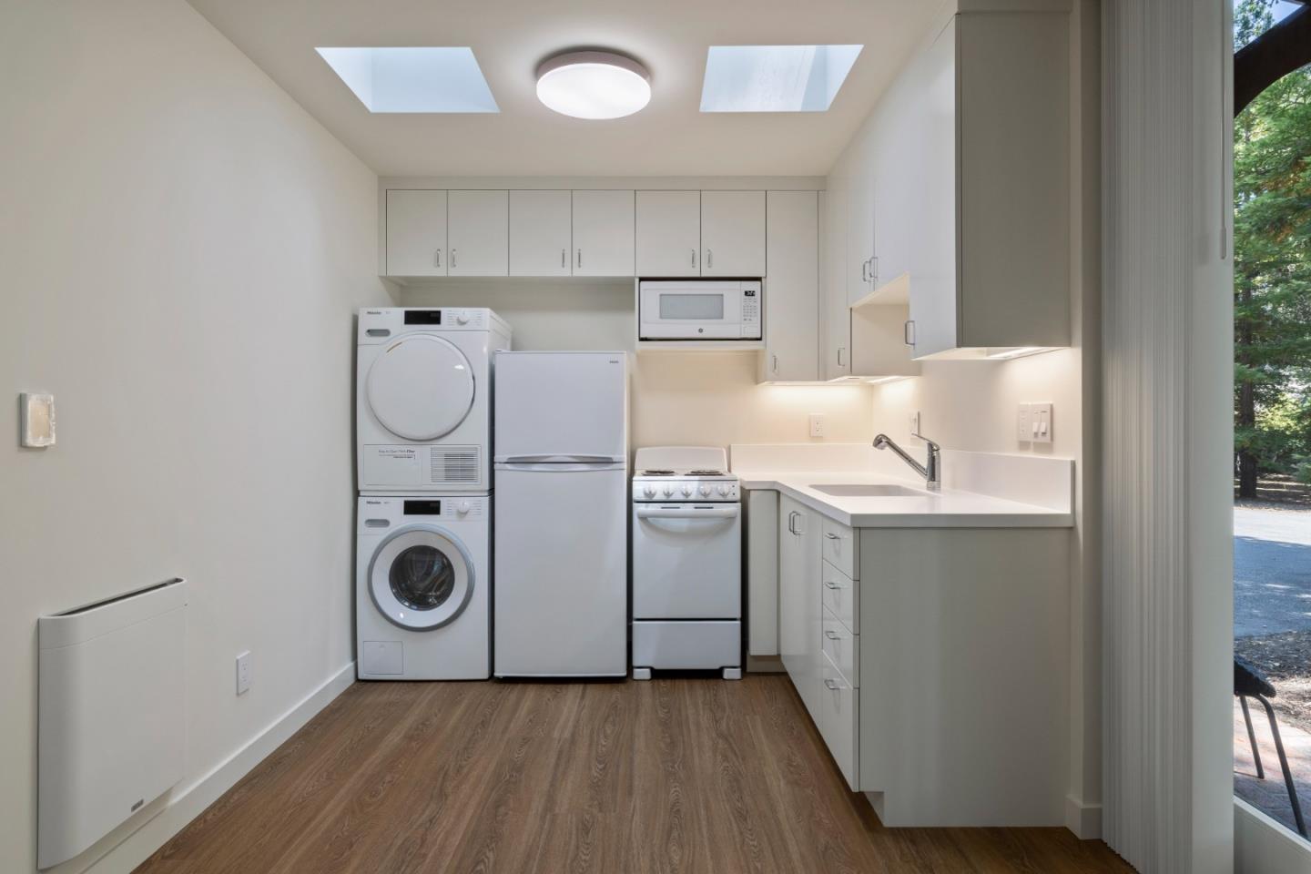 3364 Woodside Road Woodside, CA 94062 - Photo 45 of 48 a utility room with cabinets dryer and washer