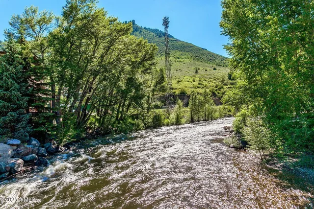 an aerial view of residential house with outdoor space and river