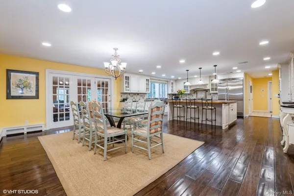 a view of a dining room with furniture a floor to ceiling window and wooden floor