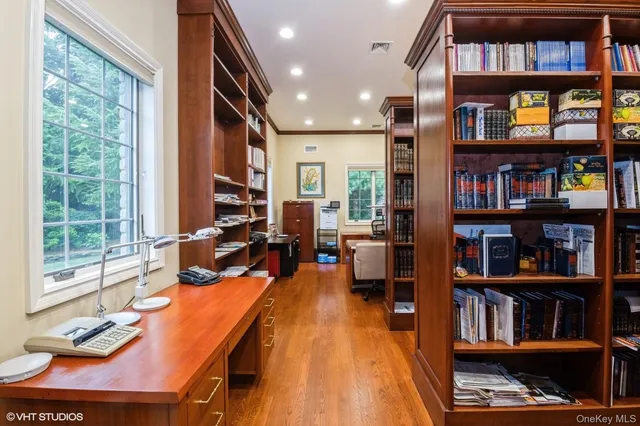 a living room with lots of furniture and a book shelf