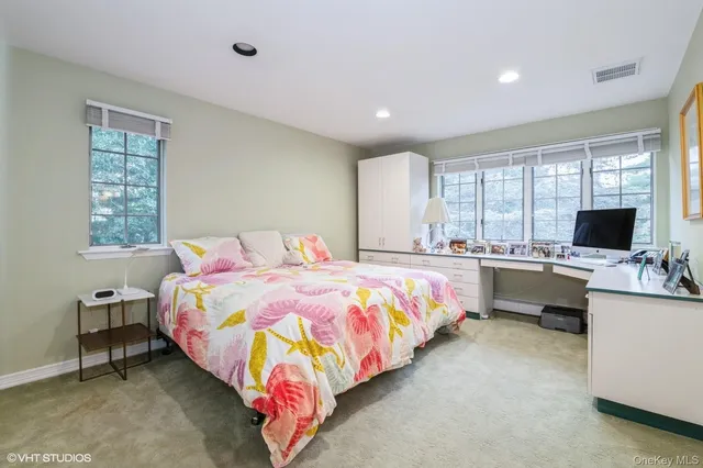 a bedroom with a bed and a desk