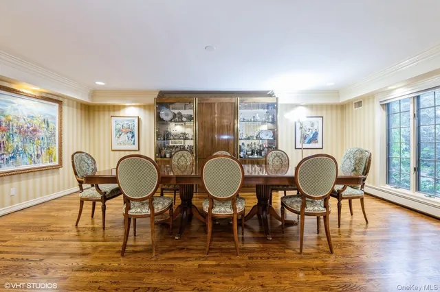 a living room with furniture dining table and wooden floor