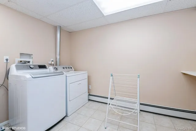 a utility room with cabinets washer and dryer