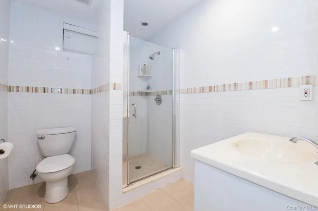 a bathroom with a toilet sink and shower