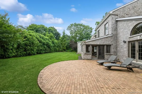 a view of a house with backyard porch and sitting area