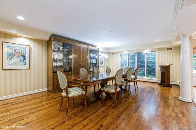 a dining room with furniture window wooden floor and a rug