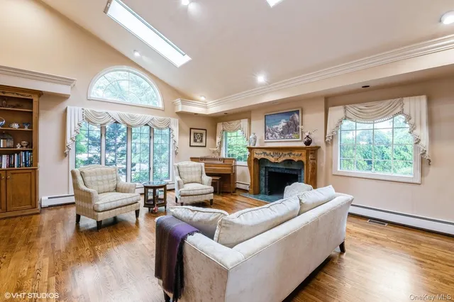 a living room with furniture large window and a fireplace