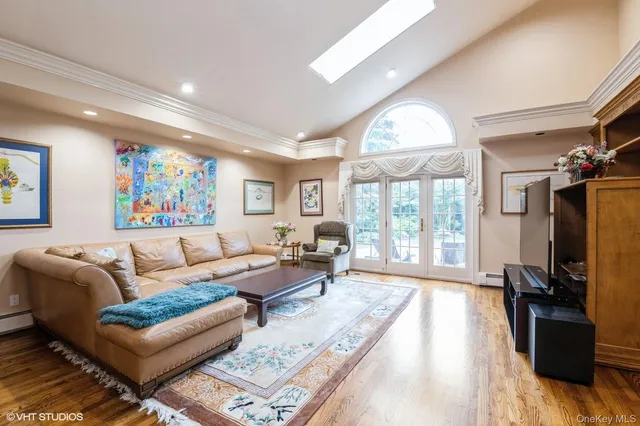 a living room with furniture fireplace and a large window