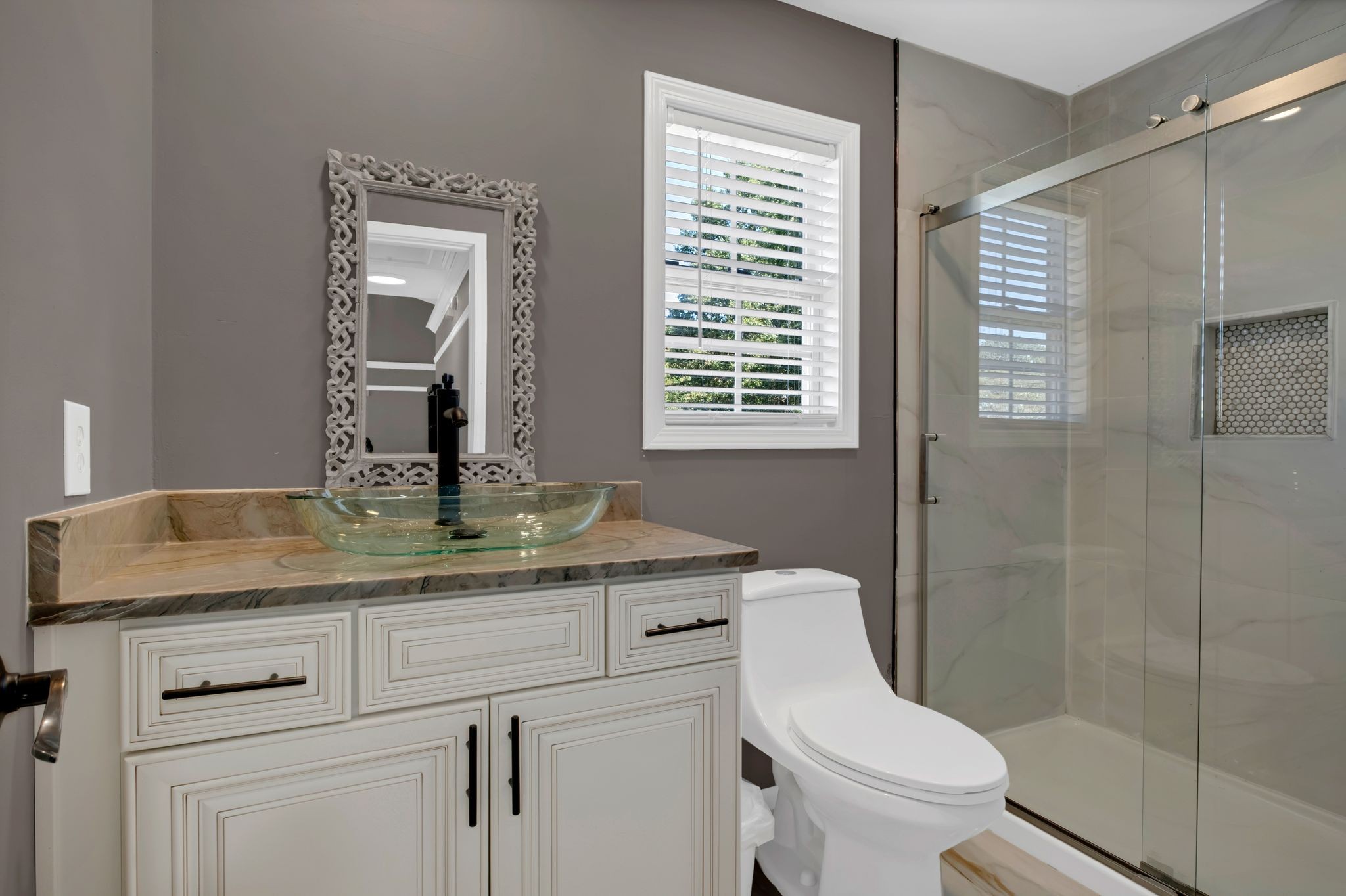 532 Windy Road Mount Juliet, TN 37122 - Photo 23 of 35 a bathroom with a granite countertop toilet a sink a mirror and shower