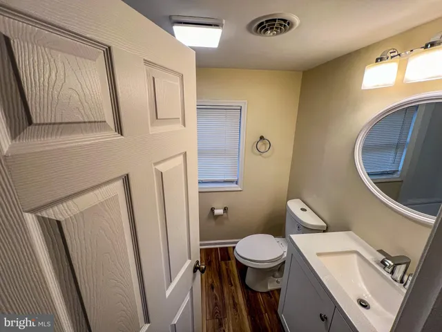 a bathroom with a toilet sink and mirror